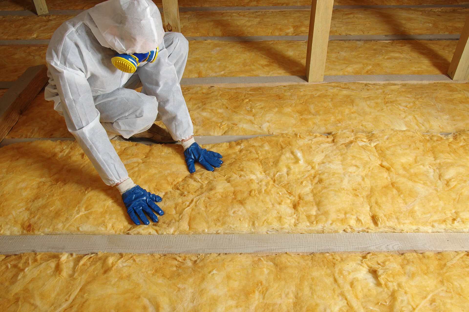 technician installing attic insulation