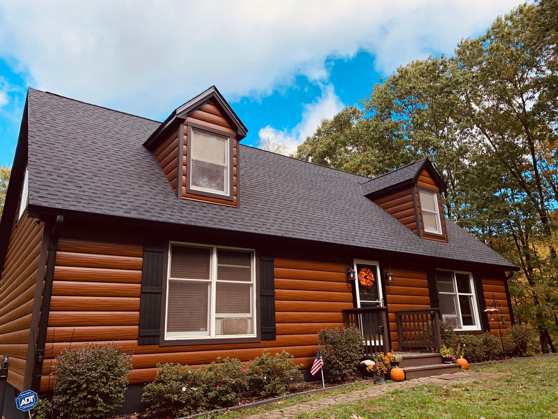 log cabin style home with shingle roofing