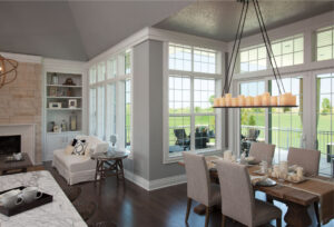 open floor plan living and dining room with fiberglass windows all along the walls