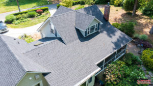 aerial view of gray asphalt roof on suburban home