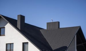 Dark grey corrugated metal roofing on a modern house