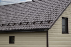 Roof on a home with tan siding