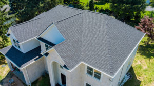An asphalt shingle roof covering a large residential home